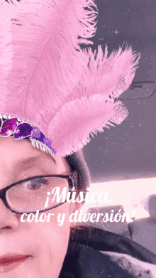 a woman wearing glasses and a pink feathered headpiece with the words " musica color y diversion " on the bottom