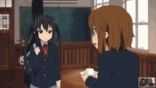 a girl in a school uniform is holding a cake