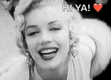 a black and white photo of marilyn monroe with the words hi ya written above her