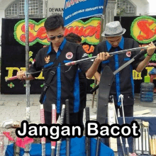 a man holding a sword in front of a sign that says dewan