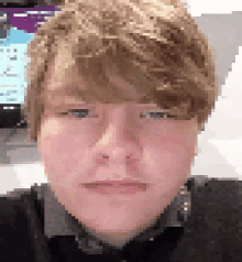 a pixelated image of a young man 's face with a serious look on his face