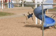 a child is falling off a slide in a playground