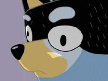 a close up of a cartoon dog 's face with a black mask on it .