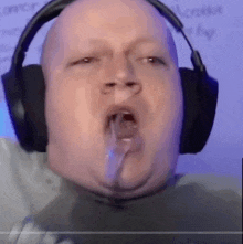 a man wearing headphones is making a funny face with his mouth open