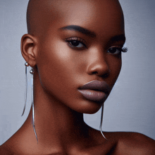 a close up of a woman 's face with earrings on her ear