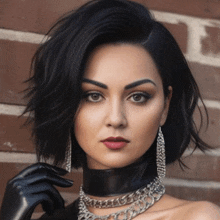 a woman wearing a choker necklace and gloves is standing in front of a brick wall