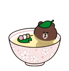 a brown bear is sitting in a bowl of soup with a green leaf on its head .