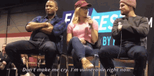 a man and two women sitting in front of a sign that says ' i 'm vulnerable right now '