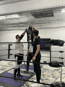 a man in a wrestling ring holds up a belt that says king of the ring