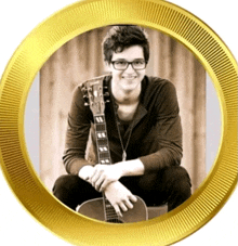 a young man sitting on a guitar with a gold circle around him