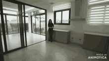 a woman is standing in an empty room with the words made in animotica on the bottom right