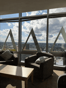 a living room with a view of a city and the letter aa on the wall