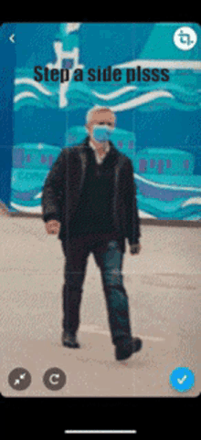 a man wearing a face mask is walking in front of a blue wall with the words step a side plsss on it