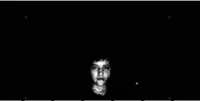 a black and white drawing of a person 's face in the dark .