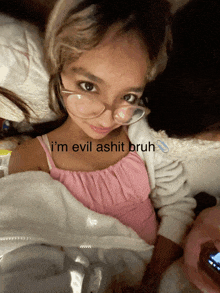 a girl wearing glasses is laying in bed with the words i 'm evil ashit bruh on the bottom