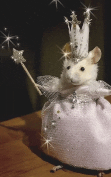 a mouse dressed up as a fairy holding a wand