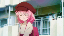 a girl with pink hair is wearing a hat and a backpack