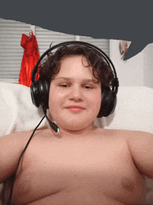 a shirtless boy wearing headphones with a microphone on his head