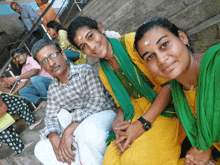 a group of people posing for a picture with one wearing a green scarf