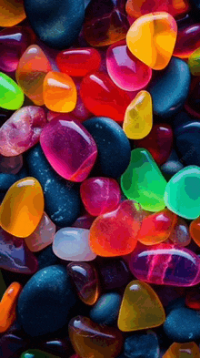 a bunch of colorful rocks are laying on a table