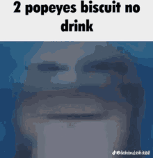 a man is drinking a popeye 's biscuit from a cup .