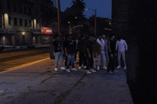 a group of men are standing on the sidewalk in front of a pawn shop