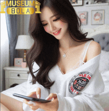 a woman sitting on a bed looking at a cell phone with the words museum bola behind her