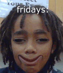 a young boy with dreadlocks is making a funny face with the words fridays written above him .