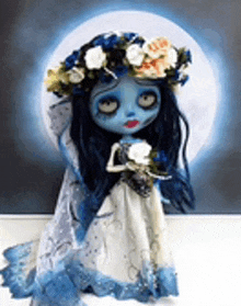 a corpse bride doll with a wreath of flowers on her head .