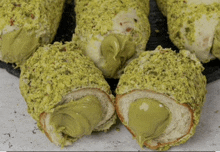 a close up of a donut with pistachios on top