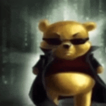 a winnie the pooh teddy bear wearing sunglasses and a black jacket .