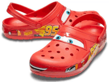 a pair of red crocs with cars 95 on them