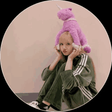 a girl wearing headphones and a purple stuffed unicorn on her head