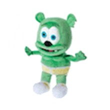 a green gummy bear with blue eyes is standing on a white surface .