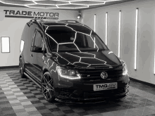 a black van is parked in a trade motor group showroom