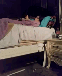 a bottle of coca cola sits on a nightstand next to a person laying on a bed