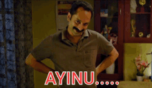 a man with a mustache is standing with his hands on his hips and ayinu written on the bottom