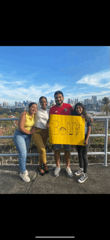 a group of people are standing next to each other holding a sign that says boys