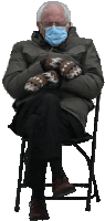 a man wearing a mask and mittens sits on a chair