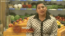 a woman is standing in front of a display of fruits and vegetables with the name jamyly on the bottom