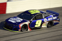 a napa auto parts race car is driving down a track