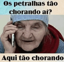 an elderly woman is crying while talking on a cell phone