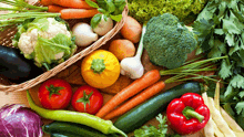 a variety of vegetables including carrots and peppers are on a table