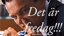 a man in a suit and tie is holding his nose in front of the words det ar fredag !!!