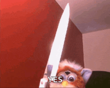 a furby doll is holding a large knife and saying yes .