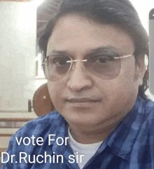 a man wearing sunglasses and a plaid shirt is asking people to vote for dr ruchin sir