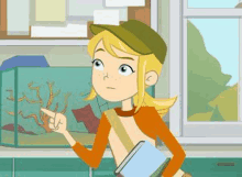 a cartoon girl is standing in front of a fish tank holding a book .