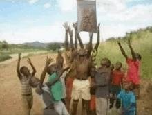 a group of people holding up a sign with a picture of a lion on it