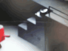 a blurred image of a red object in a room