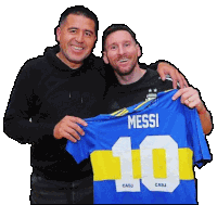 two men holding a blue jersey that says messi on the back